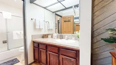 a bathroom with a sink and a mirror at Aspen Creek #115 condo in Mammoth Lakes