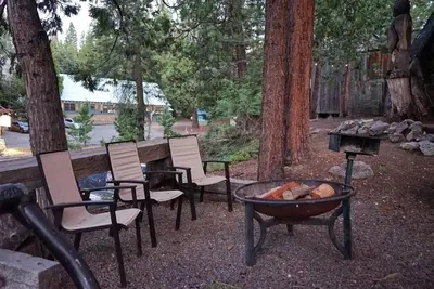 a group of chairs sitting around a fire pit at Miners Suite-Centrally Located in Shaver Lake in Shaver Lake