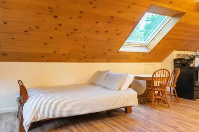a room with a bed and a table with a window at Hawks Nest- Perfect Getaway in Shaver Lake in Shaver Lake