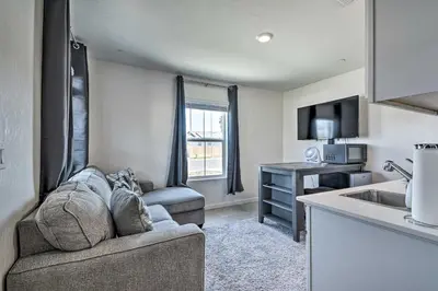 a living room with a couch and a kitchen at Contemporary Los Banos Studio Less Than 3 Mi to Dtwn! in Los Banos