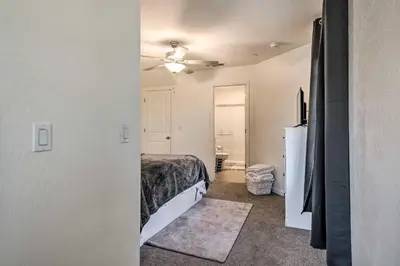 a bedroom with a bed and a white refrigerator at Contemporary Los Banos Studio Less Than 3 Mi to Dtwn! in Los Banos