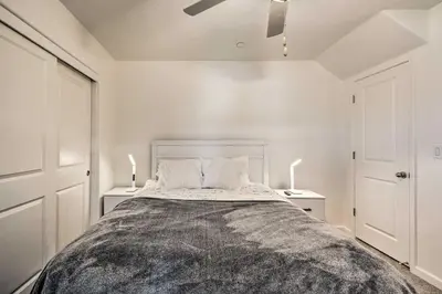 a bedroom with a large bed with two night stands at Contemporary Los Banos Studio Less Than 3 Mi to Dtwn! in Los Banos
