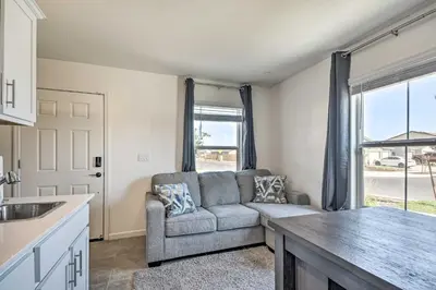 a living room with a couch and a kitchen at Contemporary Los Banos Studio Less Than 3 Mi to Dtwn! in Los Banos