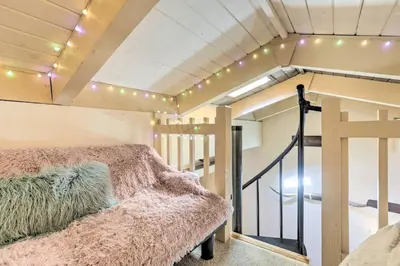 a room with a bed and a staircase with lights at 1 Mi to Diamond Peak Skiing Incline Village Condo in Incline Village