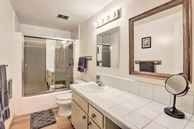 a bathroom with a sink and a toilet and a mirror at 1 Mi to Diamond Peak Skiing Incline Village Condo in Incline Village