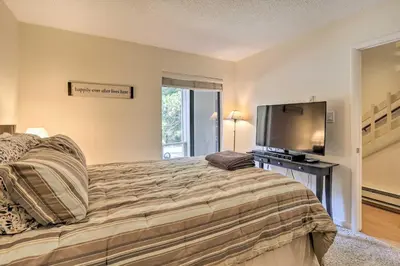 a bedroom with a large bed and a flat screen tv at 1 Mi to Diamond Peak Skiing Incline Village Condo in Incline Village