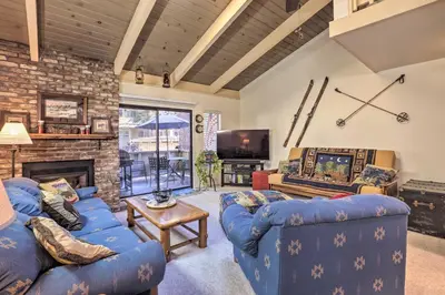 a living room with two blue couches and a fireplace at 1 Mi to Diamond Peak Skiing Incline Village Condo in Incline Village
