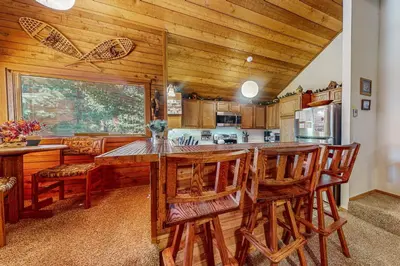 a kitchen with a large wooden table and chairs at Snowcreek 56 in Mammoth Lakes