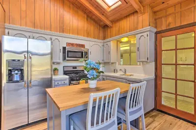 a kitchen with a refrigerator and a wooden ceiling at Lovely Oakhurst Cabin with Deck and Mtn Views! in Oakhurst