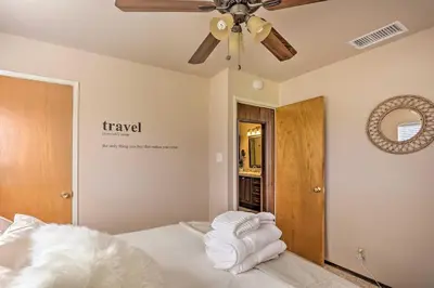 a bedroom with a bed with a ceiling fan at Lovely Oakhurst Cabin with Deck and Mtn Views! in Oakhurst