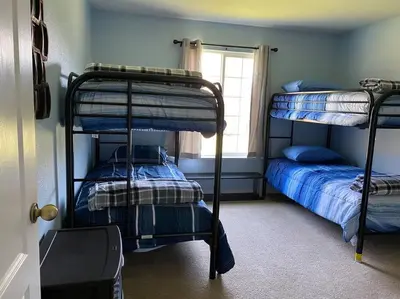 a bedroom with two bunk beds and a window at Waxberry Getaway Sequoia/Kings Canyon National Pks in Squaw Valley