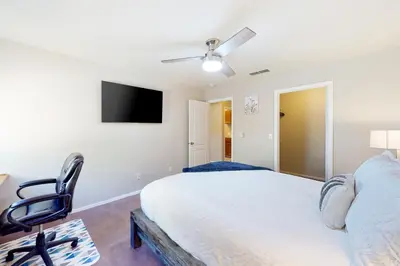 a bedroom with a bed and a chair and a tv at Five Oaks Circle Ranch in Oakhurst