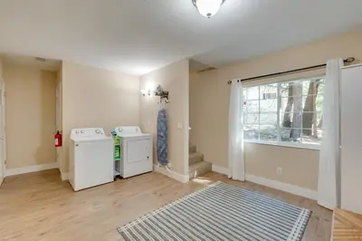a laundry room with a washer and dryer and a window at 12 Mi to Apple Hill Family-Friendly Cabin Retreat in Pollock Pines