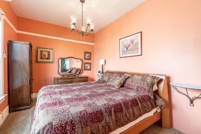 a bedroom with a bed and a mirror at Rustic 2-Bedroom walking distance to Downtown in Reno