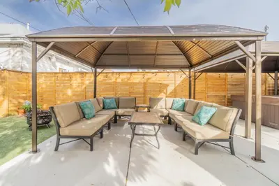a pergola with chairs and a table on a patio at Rustic 2-Bedroom walking distance to Downtown in Reno