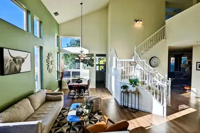 a living room with a couch and a table at King Bed Quiet Home on Cul-de-Sac Hiking Trails in Roseville