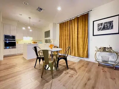 a kitchen and dining room with a table and chairs at King Bed Quiet Home on Cul-de-Sac Hiking Trails in Roseville