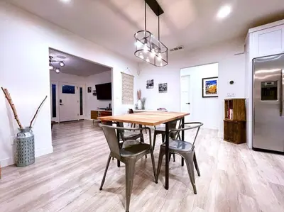 a kitchen and dining room with a wooden table and chairs at King Bed-Private Yard-Driveway Parking in Sacramento