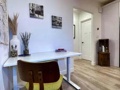 a white desk with a chair in a room at King Bed-Private Yard-Driveway Parking in Sacramento