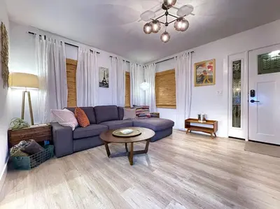 a living room with a blue couch and a table at King Bed-Private Yard-Driveway Parking in Sacramento