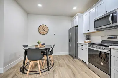 a kitchen with a table and a clock on the wall at Boho-Chic Folsom Retreat Walkable Location! in Folsom