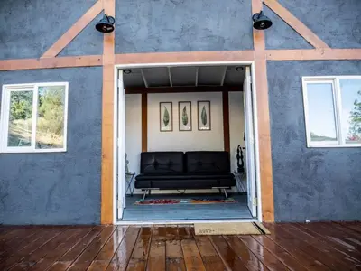 a living room with a couch in a blue wall at Pool! Quite, Private, remodeled home on the hill in Placerville