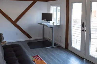 a living room with a desk with a computer on it at Pool! Quite, Private, remodeled home on the hill in Placerville