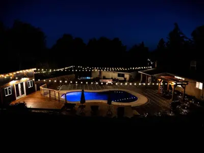 a swimming pool at night with lights around it at Pool! Quite, Private, remodeled home on the hill in Placerville