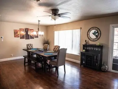 a dining room with a table and a ceiling fan at Pool! Quite, Private, remodeled home on the hill in Placerville