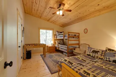 a bedroom with a bed and a wooden ceiling at Near Hikes Arnold Cabin with EV Charger and Fire Pit in Arnold