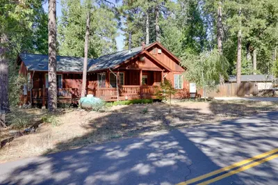 a large wooden house in the middle of a road at Near Hikes Arnold Cabin with EV Charger and Fire Pit in Arnold