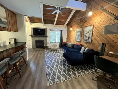a living room with a blue couch and a fireplace at 118 Standard home in Mammoth Lakes