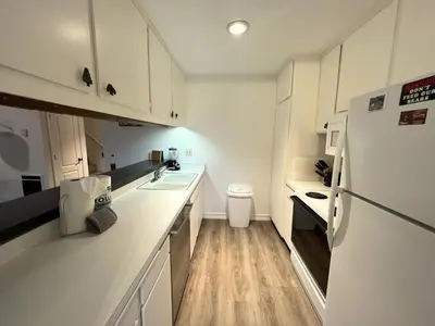 a kitchen with white cabinets and a white refrigerator at 118 Standard home in Mammoth Lakes