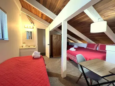 a bedroom with a red bed and a desk and a table at 118 Standard home in Mammoth Lakes