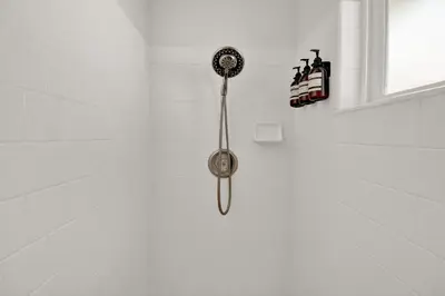 a shower with a shower head in a bathroom at Villa near Yosemite & bass lake w/Hot Tub/EVcharge in Oakhurst