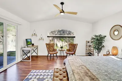 a bedroom with a bed and a ceiling fan at Villa near Yosemite & bass lake w/Hot Tub/EVcharge in Oakhurst