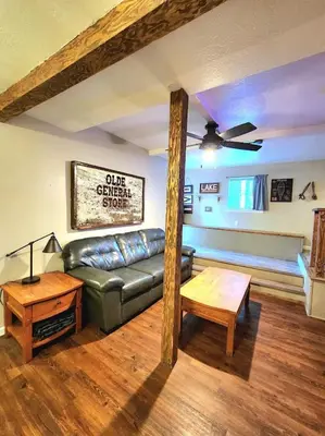 a living room with a couch and a table at Bear Cave- Pet Friendly Suite in Shaver Lake in Shaver Lake