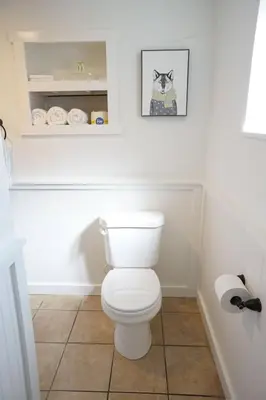 a bathroom with a toilet and a picture of a cat at Fox Den- Pet Friendly Suite in Shaver Lake in Shaver Lake
