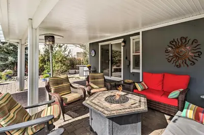 a screened in porch with a red couch and chairs at Hot Tub and Fire Pit Reno Gem 12 Mi to Skiing in Reno