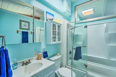 a bathroom with a toilet and a sink and a shower at Bethel Island Retreat with Private Boat Slip! in Bethel Island