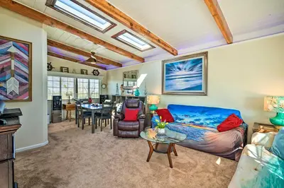 a living room with a blue couch and a table at Bethel Island Retreat with Private Boat Slip! in Bethel Island