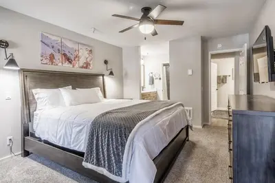 a bedroom with a bed and a ceiling fan at Aspen Creek 121 in Mammoth Lakes