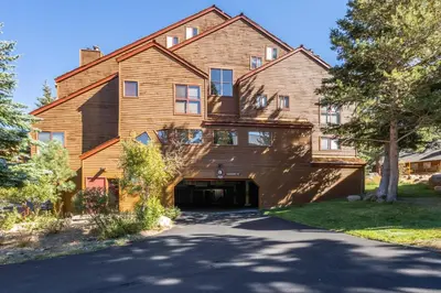 a large wooden house with a driveway at Aspen Creek 121 in Mammoth Lakes