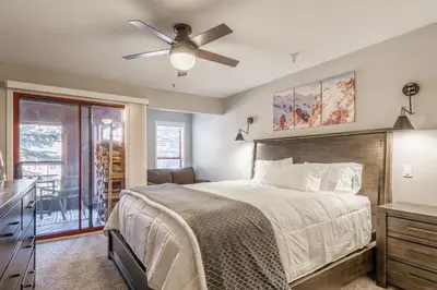 a bedroom with a bed and a ceiling fan at Aspen Creek 121 in Mammoth Lakes