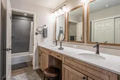 a bathroom with two sinks and a mirror at Aspen Creek 121 in Mammoth Lakes