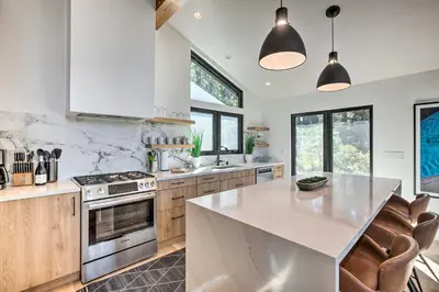 a kitchen with a white counter top and wooden cabinets at Hot Tub! Family Home 7 Mi to Diamond Peak Resort in Kings Beach