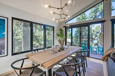 a dining room with a table and chairs and windows at Hot Tub! Family Home 7 Mi to Diamond Peak Resort in Kings Beach