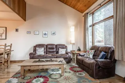 a living room with two leather chairs and a coffee table at Updated 2 Bedroom and Loft 2 Full Bathroom Woodlands #51Just Steps to Shuttle Close to Golf Course in Mammoth Lakes