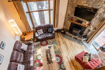 an overhead view of a living room with a stone fireplace at Updated 2 Bedroom and Loft 2 Full Bathroom Woodlands #51Just Steps to Shuttle Close to Golf Course in Mammoth Lakes