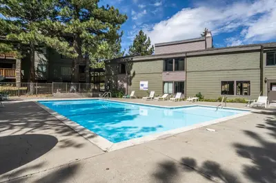 a swimming pool in front of a building at Summit #256 - Top Floor Summit 1 Bedrm 1 Bathrm Condo Just steps too Little Eagle Lodge Sleeps 4 in Mammoth Lakes